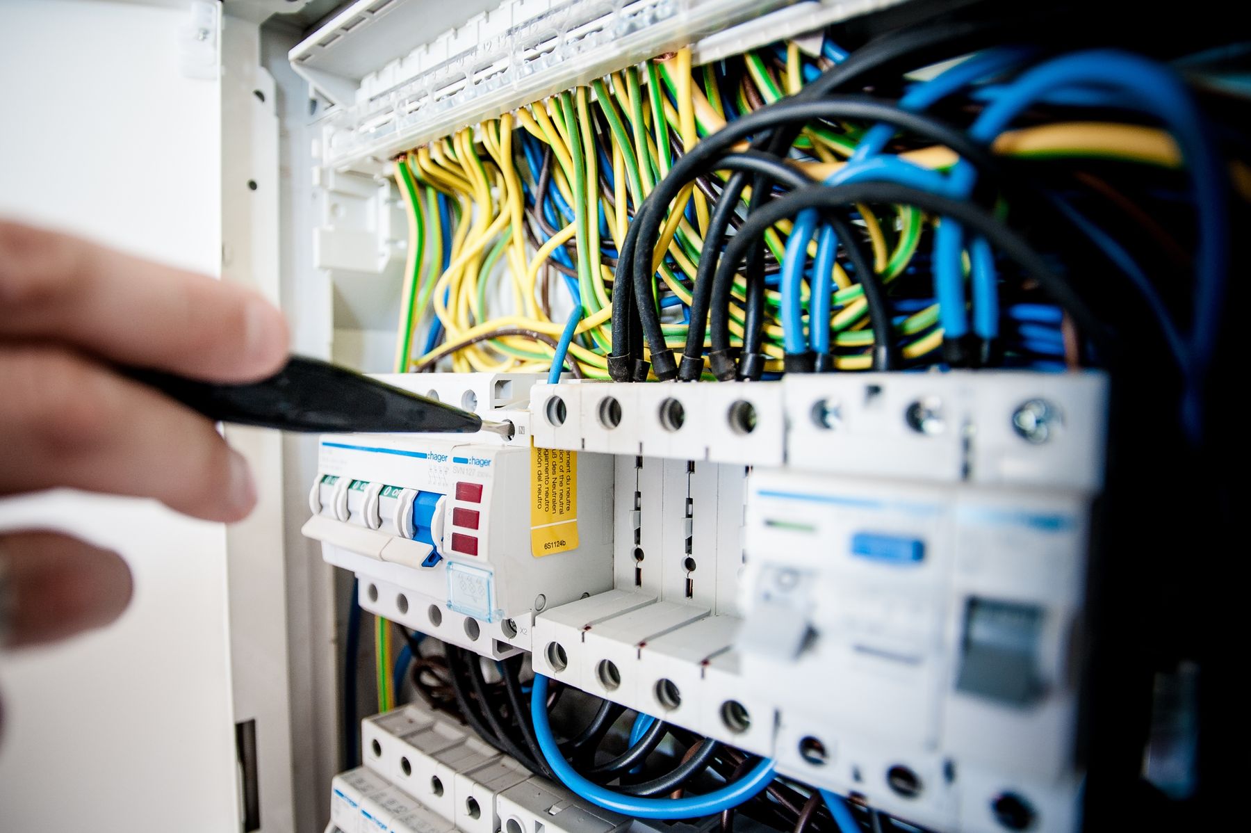 An electrician working on a switchboard